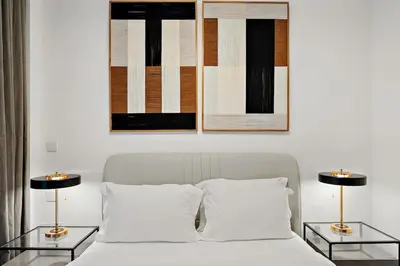 a bedroom with a white bed with two tables at FIRST CLASS 1BR Luxury Comfort Prime Location in Dubai