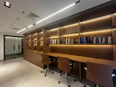 a library with a long wooden desk and chairs at FIRST CLASS 1BR Luxury Comfort Prime Location in Dubai