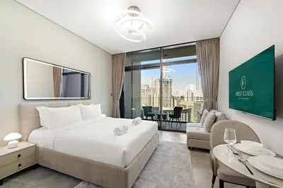 a hotel room with a bed and a view of the city at FIRST CLASS Studio Relaxing Canal View in Dubai