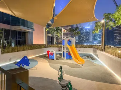 a childrens play area with a slide in a building at FIRST CLASS Studio Relaxing Canal View in Dubai