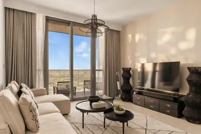 a living room with a couch and a tv at Luxury 2 Bedroom Apartment In Downtown in Dubai