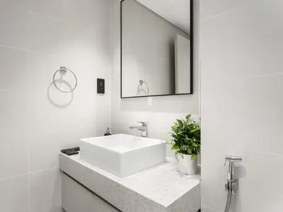 a white bathroom with a sink and a mirror at Breathtaking 1 BDR with Palm & Marina View-25 in Dubai