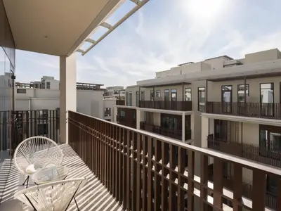 a balcony with a table and chairs on a building at The Royal Suite 1 BDR in Sunset-02 in Dubai