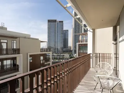 a balcony with two chairs and a view of the city at The Royal Suite 1 BDR in Sunset-02 in Dubai