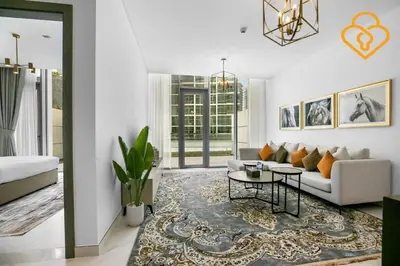 a living room with a couch and a table at Beautiful Large 1BR Apt in District 1, MBR Minutes to Downtown in Dubai