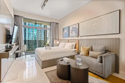 a hotel room with a bed and a couch at Chic Getaway with Downtown View, Walk to Dubai Mall and Burj in Dubai