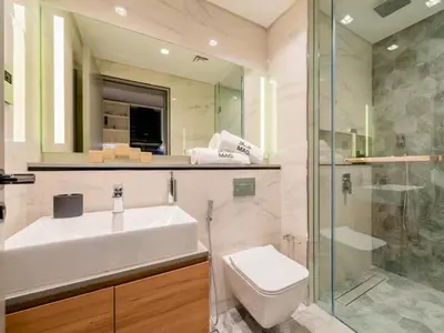 a bathroom with a sink and a toilet and a shower at Chic Getaway with Downtown View, Walk to Dubai Mall and Burj in Dubai