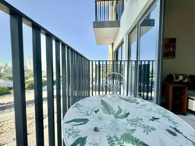 a balcony with a bed and a view of the city at 4 Months Offer Brand new Modern Prime Amenities in Dubai