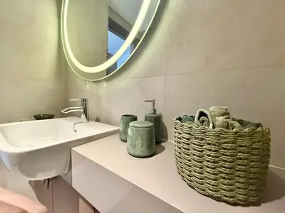 a bathroom with a sink and a basket on a counter at 4 Months Offer Brand new Modern Prime Amenities in Dubai