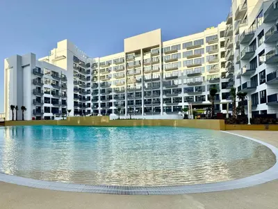a large swimming pool in front of a building at 4 Months Offer Brand new Modern Prime Amenities in Dubai