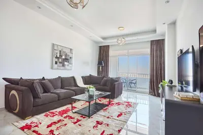 a living room with a couch and a tv at Frank Porter - Al Rabia Tower in Dubai