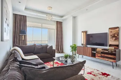 a living room with a couch and a flat screen tv at Frank Porter - Al Rabia Tower in Dubai