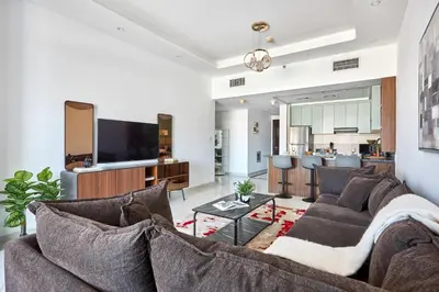a living room with a couch and a kitchen at Frank Porter - Al Rabia Tower in Dubai