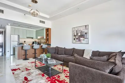 a living room with a couch and a table at Frank Porter - Al Rabia Tower in Dubai
