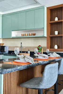 a kitchen with a counter with wine glasses on it at Frank Porter - Al Rabia Tower in Dubai