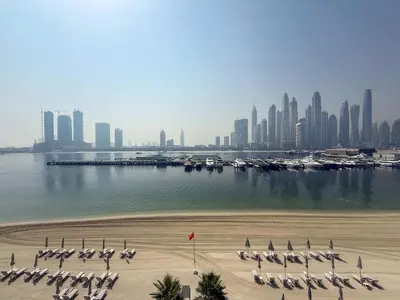 a view of a beach with a city in the background at Frank Porter - Palace Beach Residence in Dubai