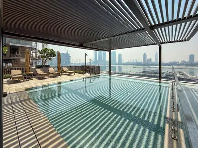 a large swimming pool on top of a building at Frank Porter - Palace Beach Residence in Dubai