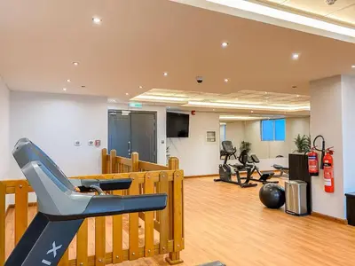 a gym with a slide in the middle of a room at Vogue Elite Business Bay Residence Close to Burj Khalifa and Dubai Mall, Studio Apartment with Balcony, City and Canal View, Access to all Amenities in Dubai