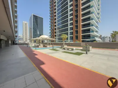 a walkway in a city with tall buildings at Vogue Elite Business Bay Residence Close to Burj Khalifa and Dubai Mall, Studio Apartment with Balcony, City and Canal View, Access to all Amenities in Dubai