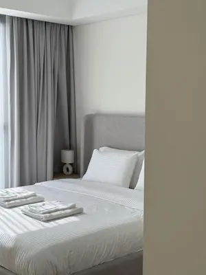 a white bed with two towels on top of it at Luxury 1BR Retreat with Dubai Marina views by Crescent Key in Dubai