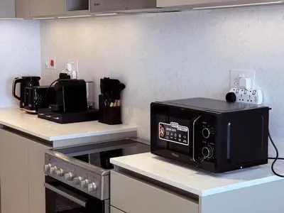 a microwave sitting on top of a kitchen counter at Luxury 1BR Retreat with Dubai Marina views by Crescent Key in Dubai