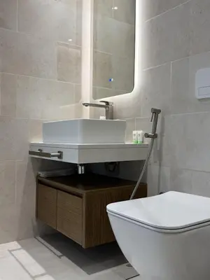 a bathroom with a sink and a toilet at Elegant 1BR with Skyline View Bright & Modern by Crescent Key in Dubai