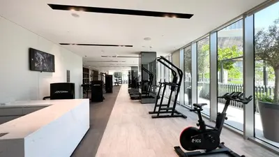 a gym with treadmills and exercise equipment in a building at INCREDIBLE BURJ KHALIFA & DUBAI FOUNTAIN Views - 2 BR Luxury Apartment - Sanctuary Stays in Dubai
