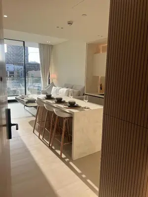 a kitchen with a bar with stools and a counter top at Elegant Dubai Stay Pool, Gym, Padel & Concierge in Dubai