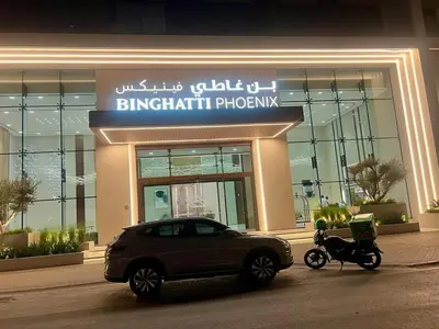 a car and a motorcycle parked in front of a building at Elegant Dubai Stay Pool, Gym, Padel & Concierge in Dubai
