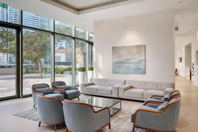 a living room with a couch and chairs and windows at Luxury Apartment in Burj Vista with Burj Khalifa View in Dubai
