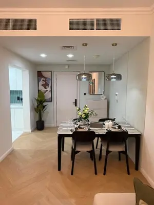 a dining room with a black table and chairs at Yansoon 4 , Old Town Downtown in Dubai