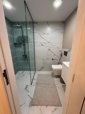 a bathroom with a shower and a toilet at Yansoon 4 , Old Town Downtown in Dubai