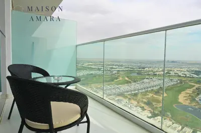a room with a table and chairs and a large window at Modern Luxurious Studio Golf View Damac Community in Dubai