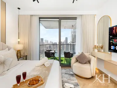 a living room with a bed and a large window at keylid-Stunning-Luxury 2BR connected to Dubai Mall in Dubai