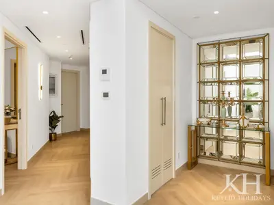 a hallway with white walls and a large window at keylid-Stunning-Luxury 2BR connected to Dubai Mall in Dubai