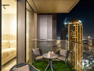 a room with a balcony with a table and chairs at keylid-Stunning-Luxury 2BR connected to Dubai Mall in Dubai