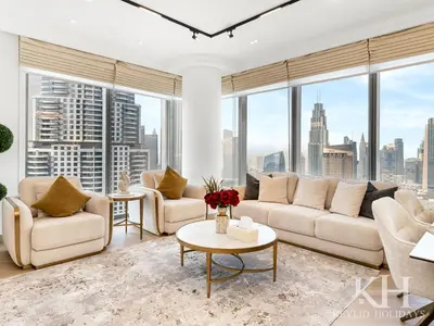 a living room with white furniture and a large window at keylid-Stunning-Luxury 2BR connected to Dubai Mall in Dubai
