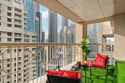 a balcony with red chairs and a view of the city at Burj Khalifa View 29 Boulevard Downtown - Free Parking in Dubai