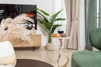 a living room with a table with a glass of wine at Burj Khalifa View 29 Boulevard Downtown - Free Parking in Dubai