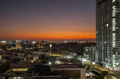 a city skyline at night with a tall building at FIRST CLASS 1BR Urban Serenity Near Downtown in Dubai