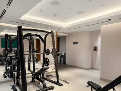 a room with a bunch of gym equipment in it at FIRST CLASS 1BR Urban Serenity Near Downtown in Dubai