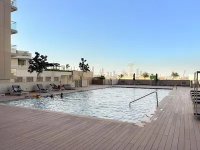 a large swimming pool on top of a building at FIRST CLASS 1BR Urban Serenity Near Downtown in Dubai