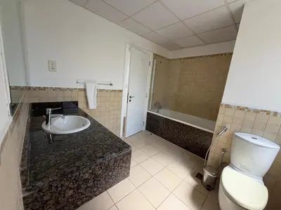 a bathroom with a toilet and a sink and a tub at 2BR Apartment in JBR The Walk in Dubai