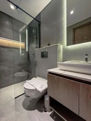 a bathroom with a toilet and a sink and a shower at Nasma Luxury Stays - Contemporary Calm Living Space with upscale Facilities in Dubai