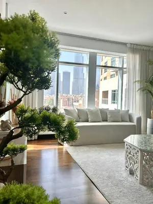 a living room with a couch and a large window at Premium Downtown 1BD Apartment Burj Khalifa View 9 Mins walk Dubai Mall in Dubai