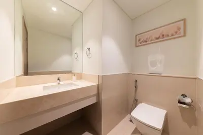 a bathroom with a sink and a toilet at Luxury 3BR Burj View in Downtown Dubai in Dubai