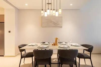 a dining room with a table and chairs at Luxury 3BR Burj View in Downtown Dubai in Dubai
