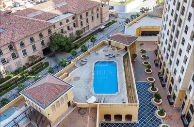 an overhead view of a building with a swimming pool at Sea View Spacious Apartment in JBR in Dubai