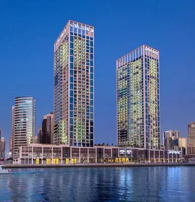 two tall buildings in a city next to the water at Studio with Pool & Canal Views - Near Dubai Mall - Downtown in Dubai