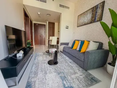 a living room with a couch and a television at BurjKhalifa View | 1BR Business Bay Near Dubaimall in Dubai